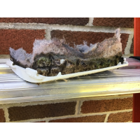 Lint collected on the inside of a vent cover, blocking airflow.
